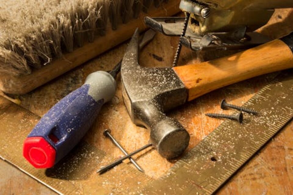 Woodworking tools and hardware on a workbench