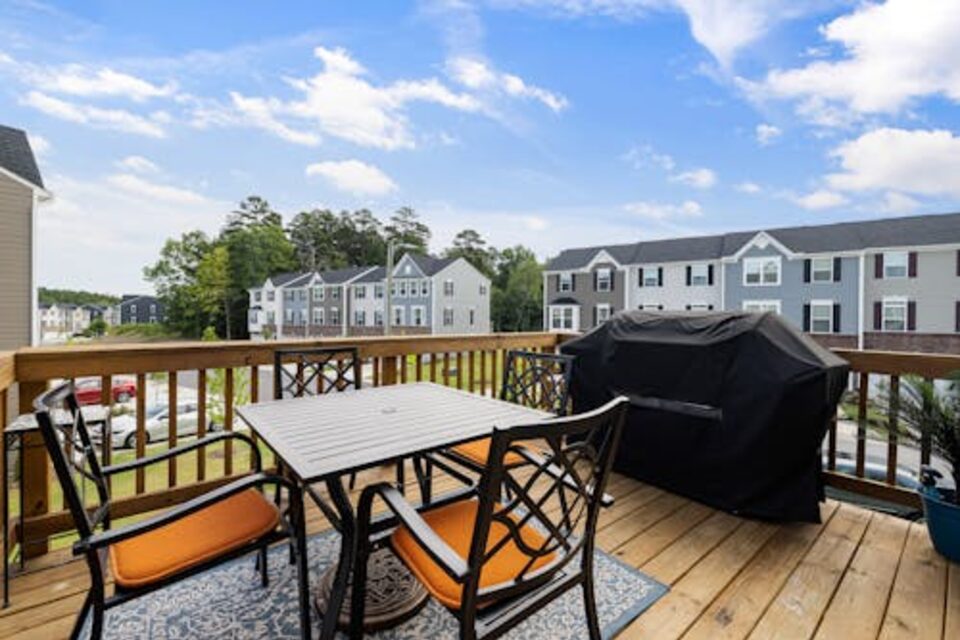 Residential deck patio with outdoor seating and grill