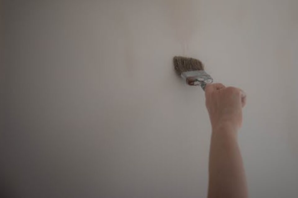 Painter applying a fresh coat of paint